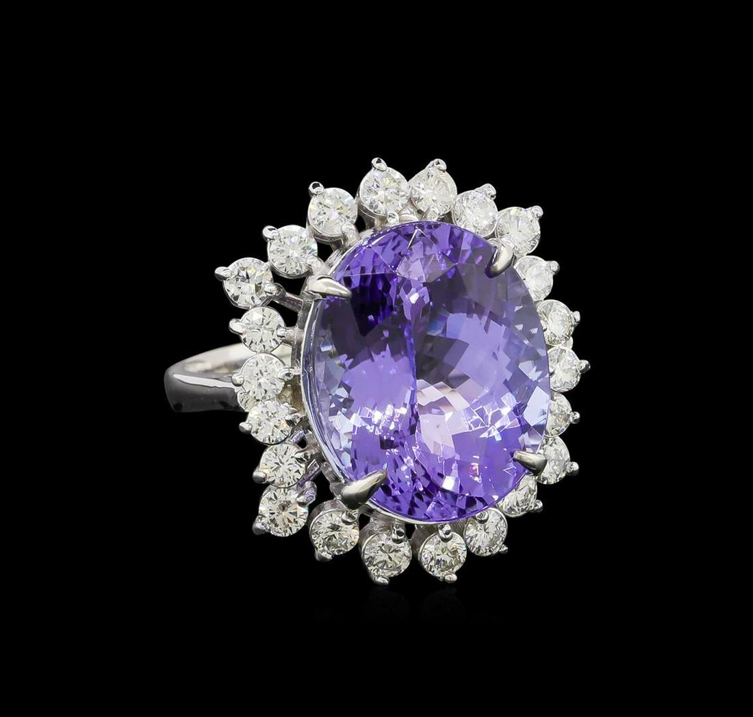 11.57 ctw Tanzanite and Diamond Ring - 14KT White Gold: One electronically tested 14KT white gold lady's cast fashion ring with a staggered basket halo with a bright polish finish. The featured lady's ring has a shank measuring 2.65 millimeters wide. Ident