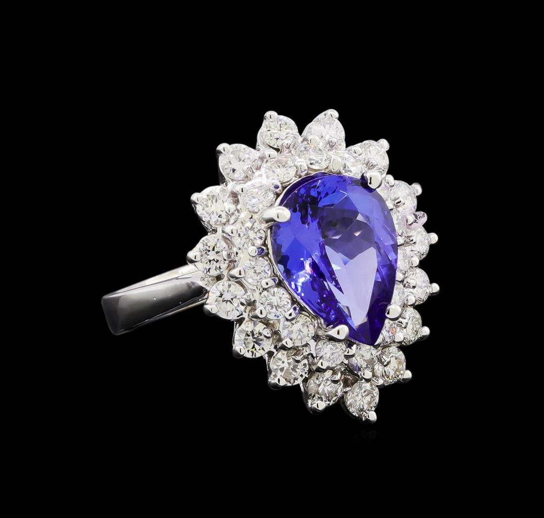3.33 ctw Tanzanite and Diamond Ring - 14KT White Gold: One electronically tested 14KT white gold lady's cast fashion ring with a double halo with a bright polish finish. The featured lady's ring has a shank measuring 2.77 millimeters in width. Identified 