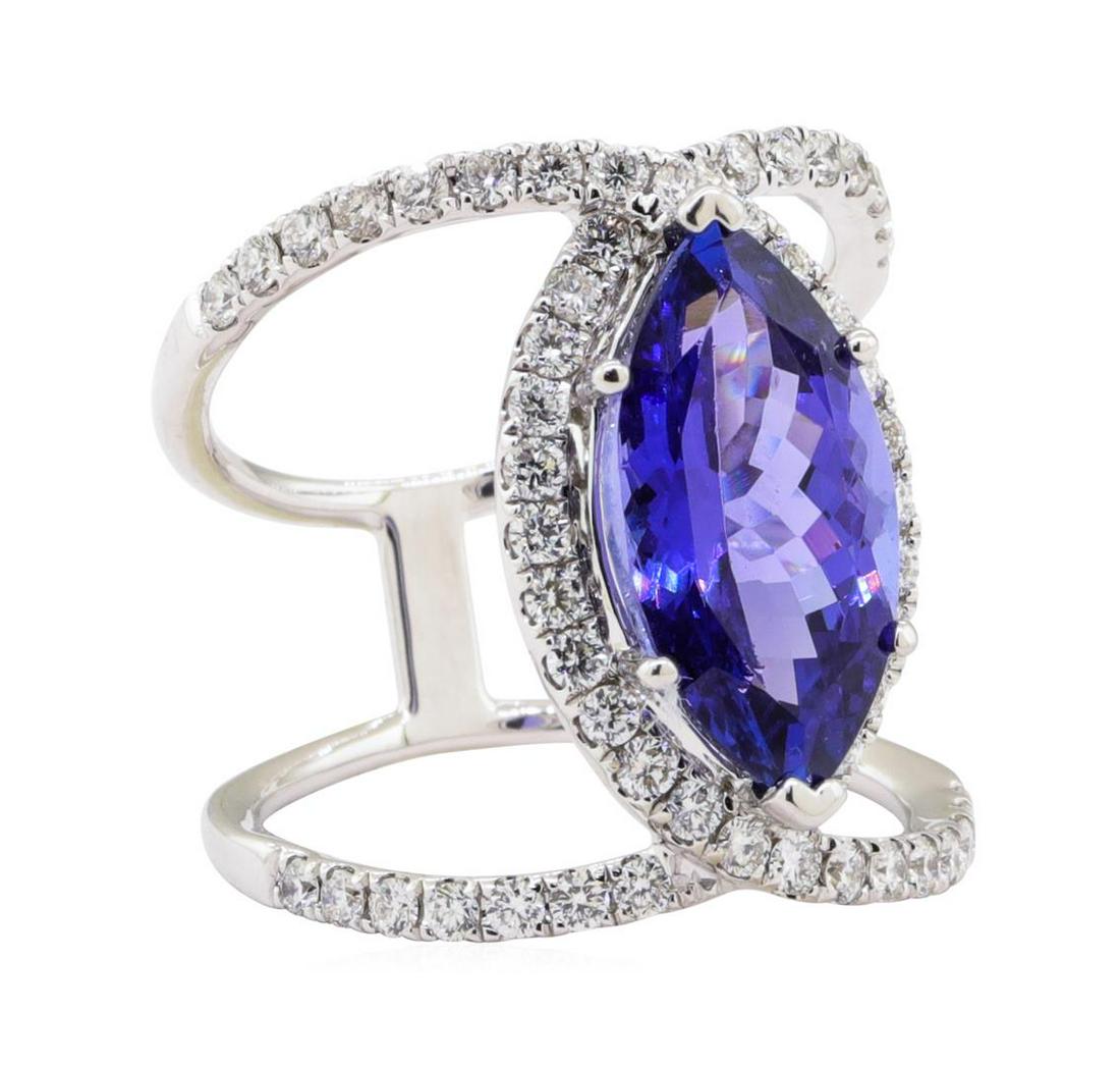 5.24 ctw Tanzanite and Diamond Ring - 18KT White Gold: One electronically tested 18KT white gold ladies cast & assembled tanzanite & diamond ring. The featured tanzanite is set within a diamond bezel, supported by diamond ribbon shoulders that attach in t