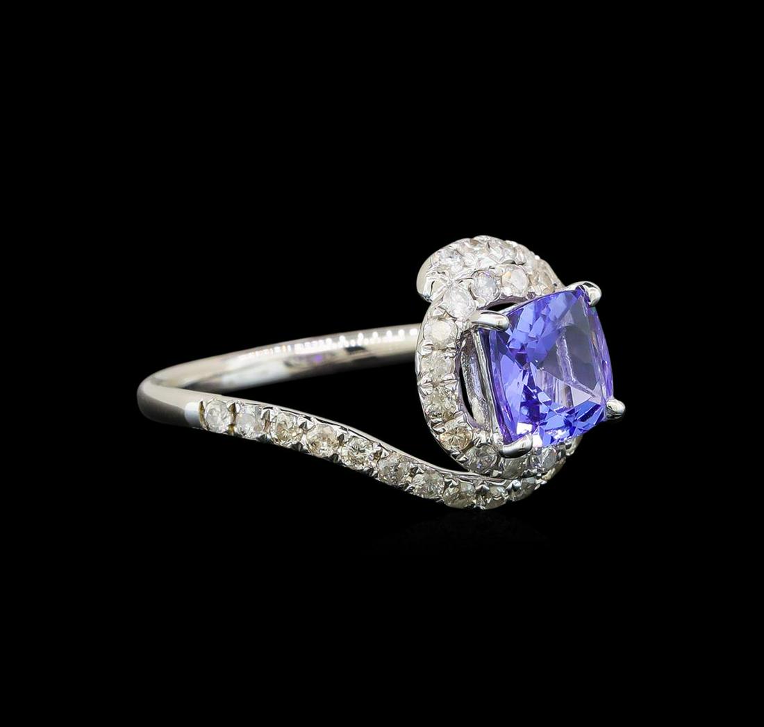 14KT White Gold 1.41 ctw Tanzanite and Diamond Ring: One electronically tested 14KT white gold ladies cast tanzanite and diamond ring with a bright polish finish. Identified with markings of "14K". Condition is new. Containing: One prong set square cush
