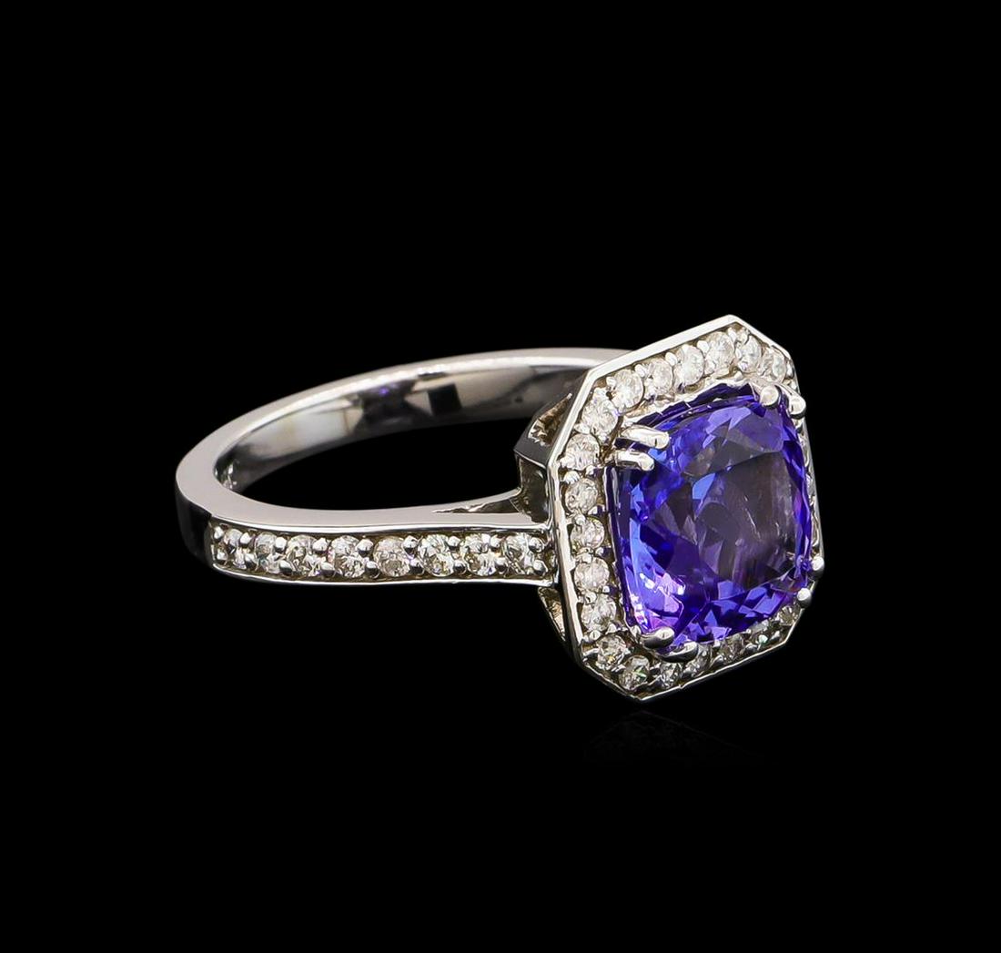 2.95 ctw Tanzanite and Diamond Ring - 14KT White Gold: One electronically tested 14KT white gold lady's cast fashion ring with a square basket halo with a bright polish finish. The featured lady's ring has a shank measuring 2.27 millimeters wide. Identifi