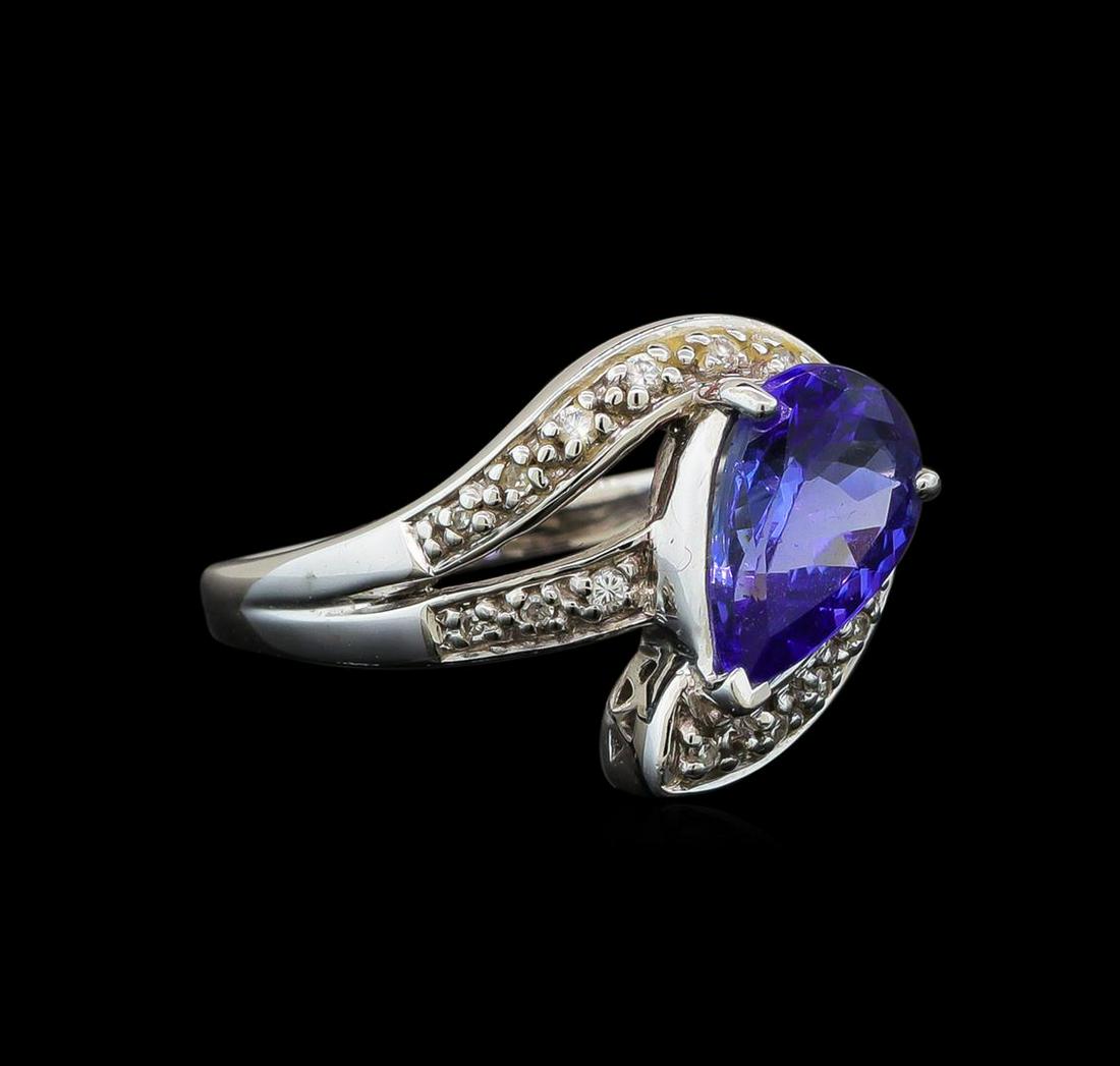18KT White Gold 1.72 ctw Tanzanite and Diamond Ring: One electronically tested 18KT white gold ladies cast tanzanite and diamond ring with a bright polish finish. Identified with markings of "18K". Condition is new. Containing: One prong set pear modifi