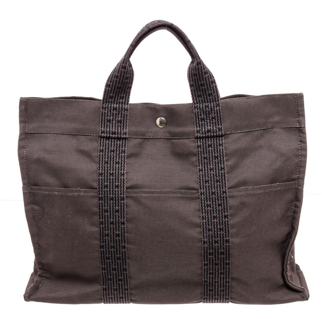 Hermes Black Gray Canvas Herline Bag GM Tote Bag: Hermes Black Gray Canvas Herline Bag GM Tote Bag. Hermes Black Gray Canvas Herline Bag GM Tote Bag with silver-tone hardware, interior slip pockets, canvas lining, dual top handles, and snap closure.