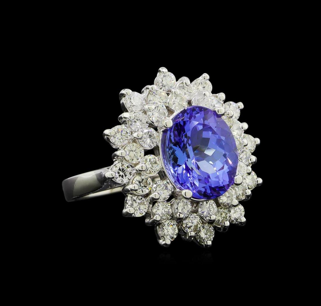 3.90 ctw Tanzanite and Diamond Ring - 14KT White Gold: One electronically tested 14KT white gold lady's cast fashion ring with a triple basket halo with a bright polish finish. The featured lady's ring has a shank measuring 2.35 millimeters wide. Identifi
