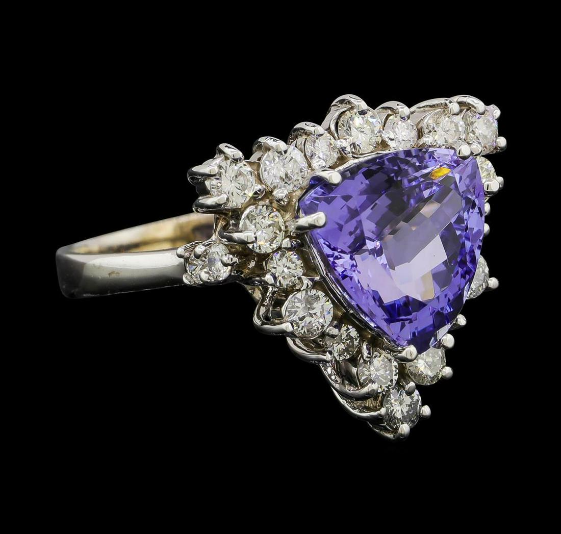 4.17 ctw Tanzanite and Diamond Ring - 14KT White Gold: One electronically tested 14KT white gold lady's cast fashion ring with a basket halo with a bright polish finish. The featured lady's ring has a shank measuring 2.50 millimeters wide. Identified with