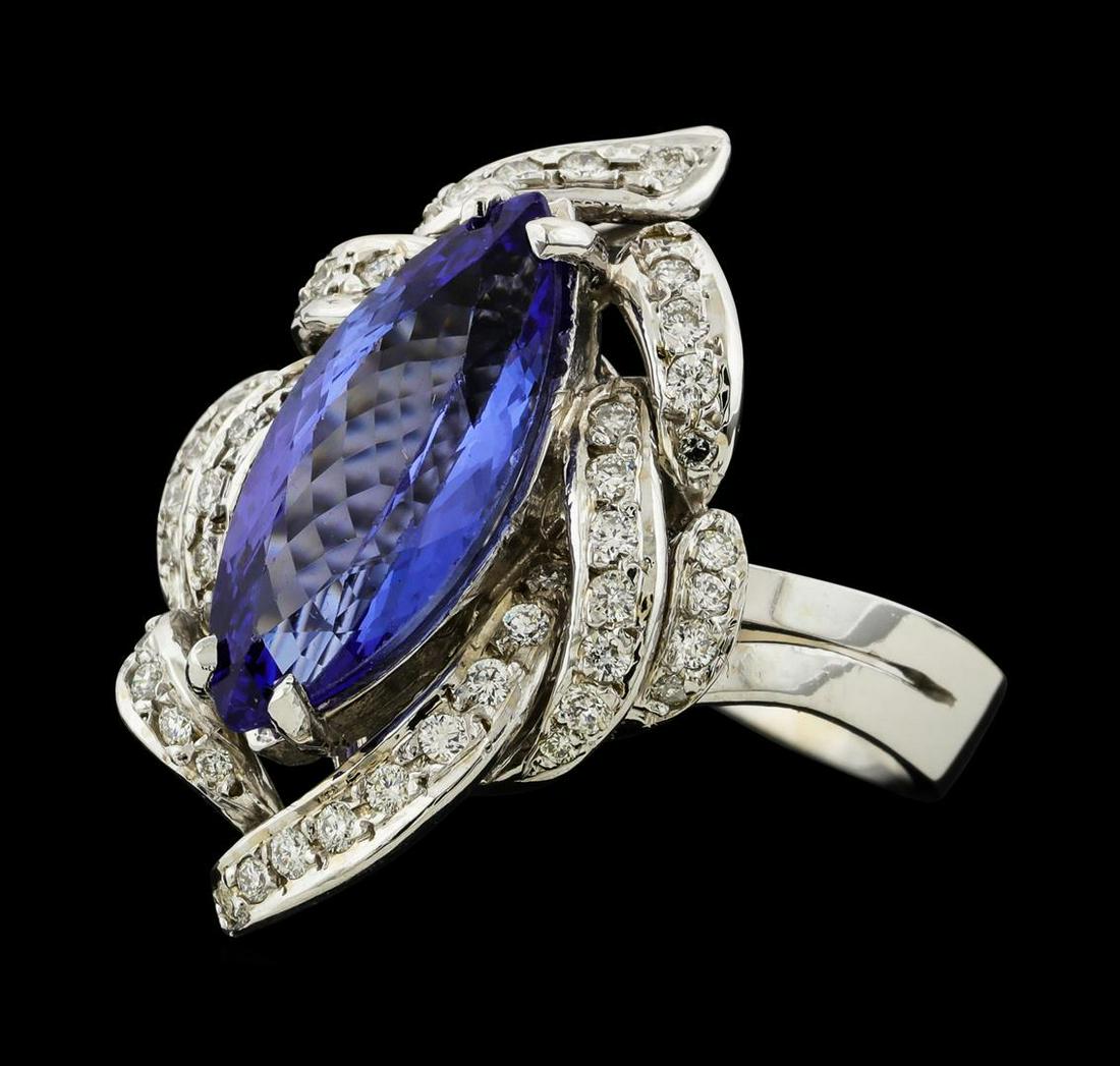 3.81 ctw Tanzanite and Diamond Ring - 14KT White Gold: One electronically tested 14KT white gold lady's cast fashion ring with a freeform diamond wreath with a bright polish finish. The featured lady's ring has a split shank measuring 3.36 millimeters wid