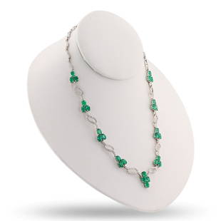 11.92 ctw Emerald and 3.64 ctw Diamond 18K White Gold Necklace: One electronically tested 18KT white gold ladies cast and assembled emerald and diamond necklace. Condition is new, good workmanship. The seventeen inch length necklace features a flexible ribbon of