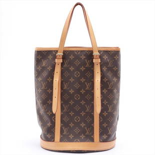 Louis Vuitton Monogram Canvas Leather Bucket GM Shoulder Bag: Brown and tan monogram Louis Vuitton Bucket GM with brass hardware, tan vachetta leather accents, dual flat shoulder straps, beige Taiga leather interior and dual pockets; one with zip closure at
