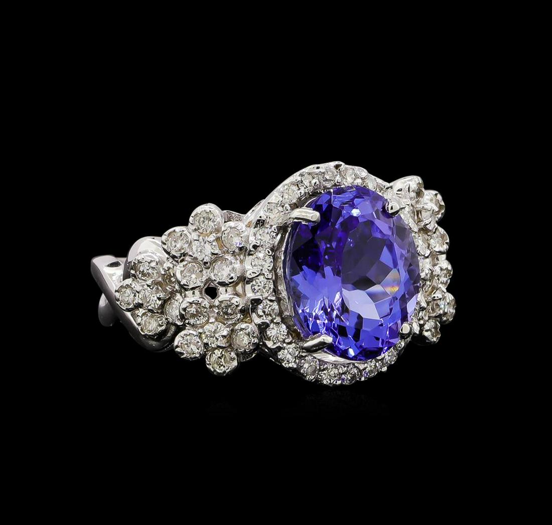 14KT White Gold 4.31 ctw Tanzanite and Diamond Ring: One electronically tested 14KT white gold ladies cast tanzanite and diamond ring with a bright polish finish. Identified with markings of "14K". Condition is new. Containing: One prong set oval modifi