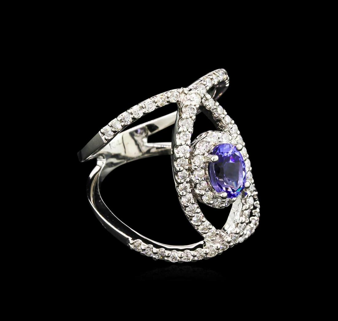 0.99 ctw Tanzanite and Diamond Ring - 14KT White Gold: One ring featuring: 14KT gold weighing 6.25 grams containing one tanzanite with a total weight of 0.99ct and 70 diamonds with a total weight of 0.85ct.