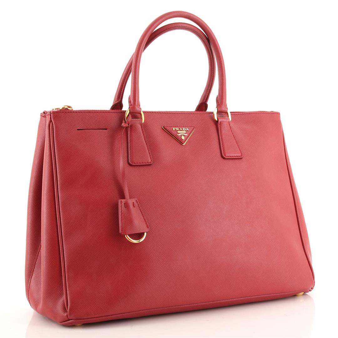 Prada Double Zip Lux Tote Saffiano Leather Large: Prada Double Zip Lux Tote Saffiano Leather Large. Odor in interior. Loss of shape, wear and marks on exterior, nicks on front base corner, moderate wear on handles. Heavy cracking on side opening wax