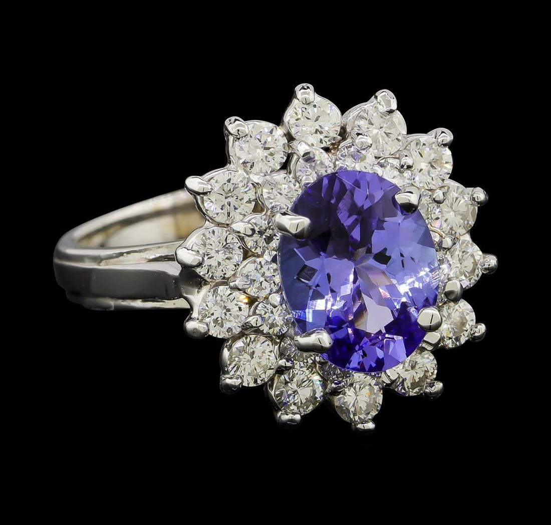 2.17 ctw Tanzanite and Diamond Ring - 14KT White Gold: One electronically tested 14KT white gold lady's cast fashion ring with a double basket halo with a bright polish finish. The featured lady's ring has a shank measuring 2.50 millimeters wide. Identifi