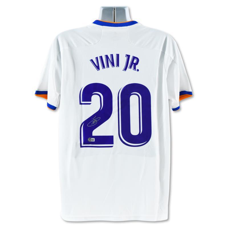 Vini Jr Real Madrid Jersey by Junior, Vini: This is a replica Real Madrid soccer jersey autographed by Vini Jr. This piece is presented with a Certificate of Authenticity from Beckett with a QR code and certification number. Measures approx. 30