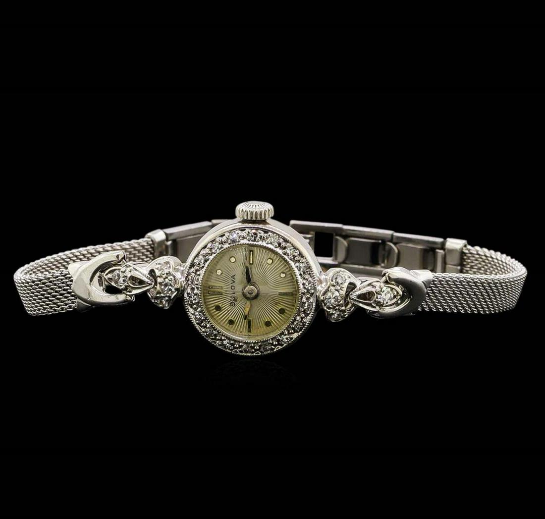 Bulova 14KT and 10KT White Gold 0.22 ctw Diamond Ladies Watch: One ladies, vintage Bulova diamond wristwatch electronically tested, 14KT white gold Case: 15mm diameter, Scalloped Crown: dial & movement set, Bezel: diamond, Crystal: domed acrylic. Case No. 59875.S