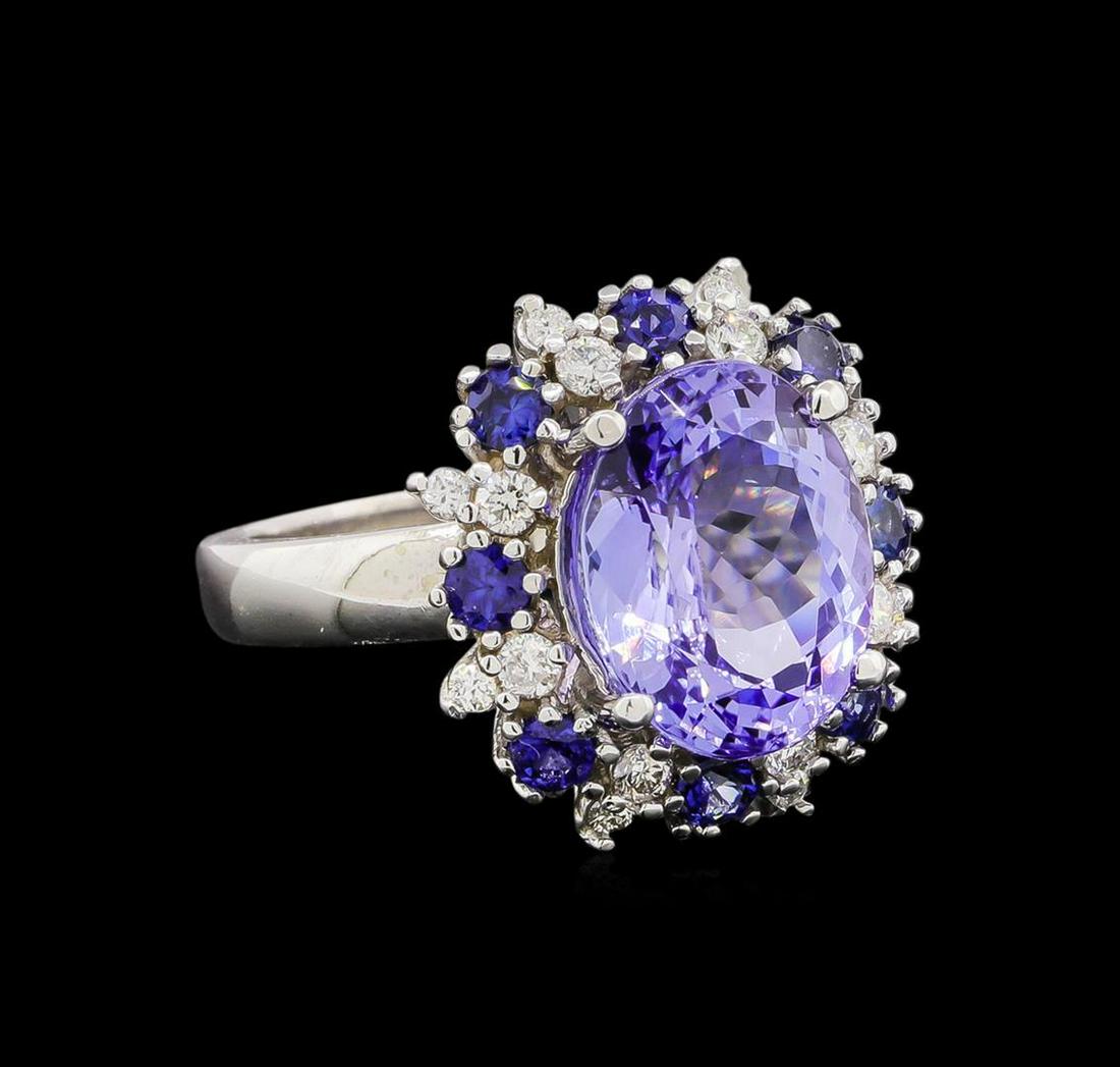 14KT White Gold 5.88 ctw Tanzanite, Sapphire and Diamond Ring: One electronically tested 14KT white gold ladies cast tanzanite, sapphire and diamond ring with a bright polish finish. Identified with markings of "14K". Condition is new. Containing: One prong set o