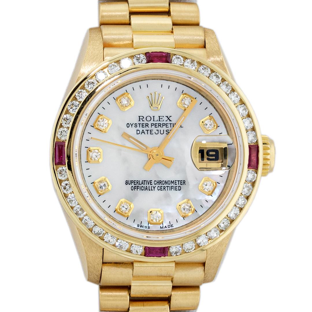 Rolex Ladies 18K Yellow Gold MOP Diamond & Ruby President Wristwatch: One Ladies Pre Owned 18K Yellow Gold Rolex President Polished, Serviced & Electronically Tested, Yellow Gold Case: 26mm, 18K Yellow Gold Crown, Custom Bezel: New 18K Yellow Gold Ruby Channel Set Diamo