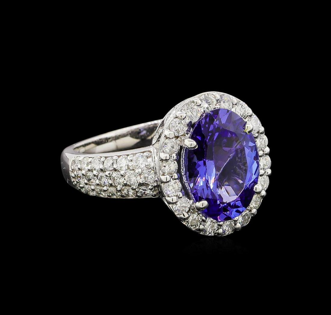 3.16 ctw Tanzanite and Diamond Ring - 14KT White Gold: One electronically tested 14KT white gold lady's cast fashion ring with a halo with a bright polish finish. The featured lady's ring has a shank measuring 2.31 millimeters wide. Identified with markin
