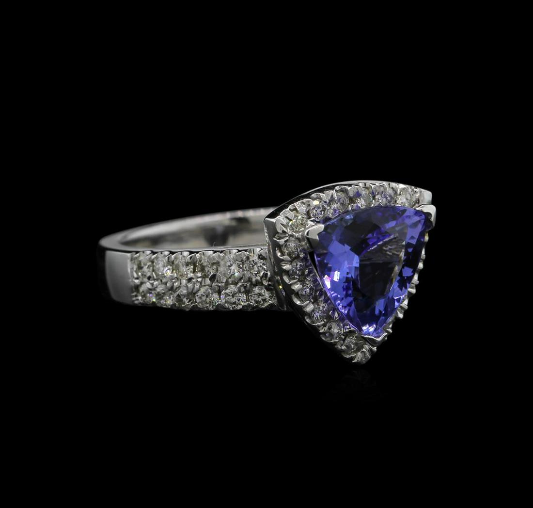 1.96 ctw Tanzanite and Diamond Ring - 14KT White Gold: One ring featuring: 14KT white gold weighing 5.77 grams containing one tanzanite center stone with a total weight of 1.96ct and 42 diamonds with a total weight of 0.63ct.