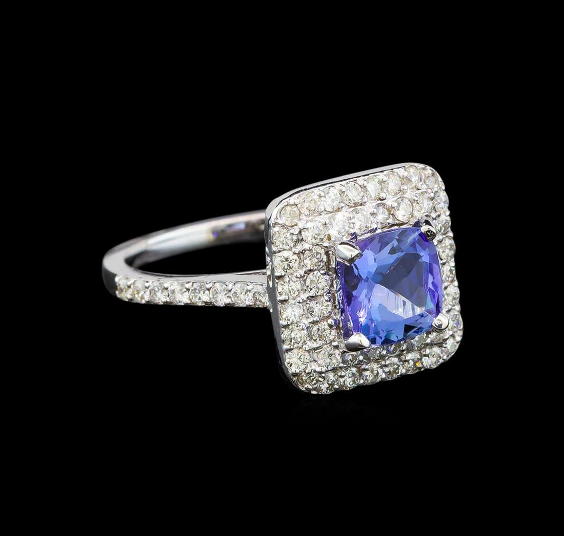 14KT White Gold 1.61 ctw Tanzanite and Diamond Ring: One electronically tested 14KT white gold ladies cast tanzanite and diamond ring with a bright polish finish. Identified with markings of "K14". Condition is new. Containing: One prong set square cush