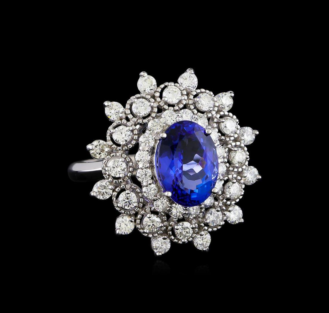 3.88 ctw Tanzanite and Diamond Ring - 14KT White Gold: One electronically tested 14KT white gold lady's cast fashion ring with a triple halo with a bright polish finish. The featured lady's ring has a shank measuring 3.0 millimeters in width. Identified w