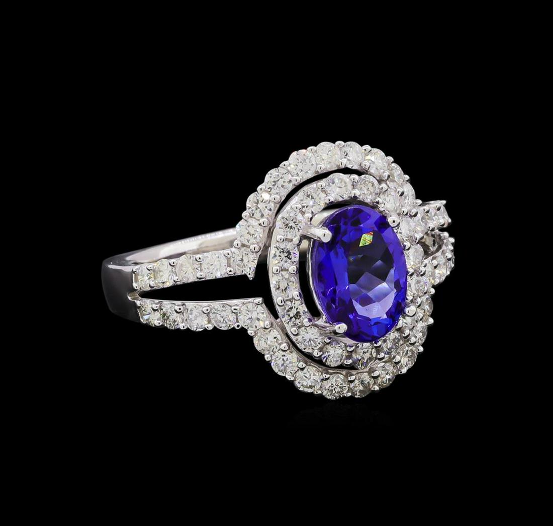 14KT White Gold 1.37 ctw Tanzanite and Diamond Ring: One electronically tested 14KT white gold ladies cast tanzanite and diamond ring with a bright polish finish. The featured tanzanite is set within two tiered diamond bezels supported by diamond set sp