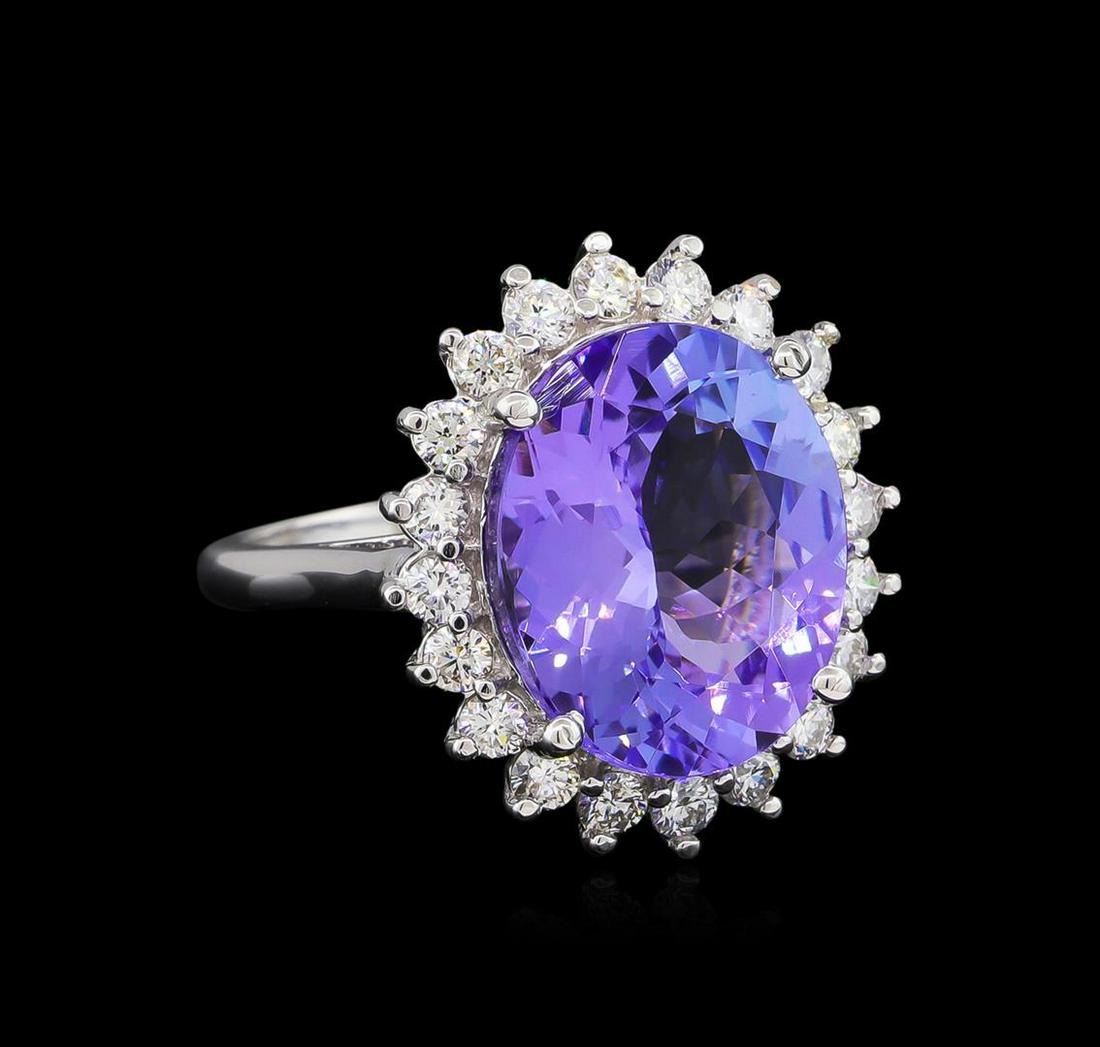 9.62 ctw Tanzanite and Diamond Ring - 14KT White Gold: One electronically tested 14KT white gold ladies cast tanzanite and diamond ring with a bright polish finish. The featured tanzanite is set within a diamond bezel supported by a ribbed under gallery, 