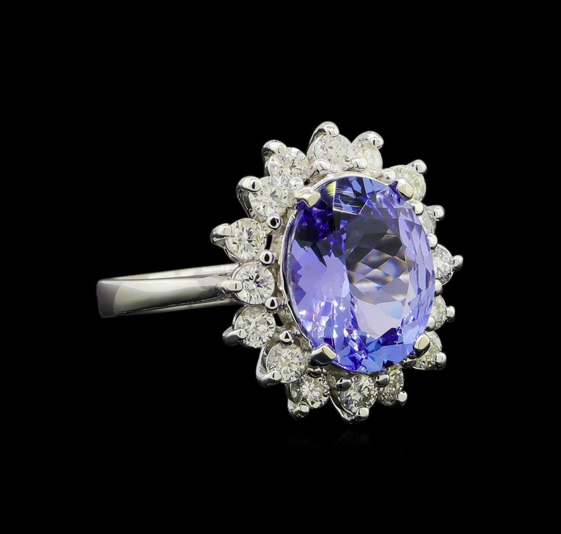 3.58 ctw Tanzanite and Diamond Ring - 14KT White Gold: One electronically tested 14KT white gold lady's cast fashion ring with a basket halo with a bright polish finish. The featured lady's ring has a shank measuring 2.44 millimeters wide. Identified with