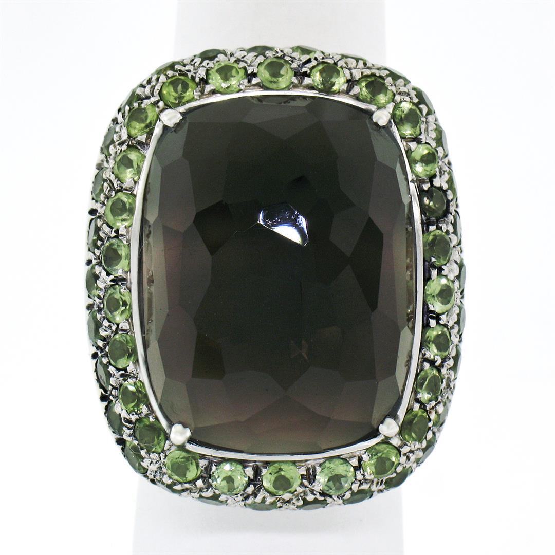 18K White Gold 37.60 ctw Large Faceted Smokey Topaz Solitaire & Peridot Halo Rin: An estate solid 18k white gold solitaire ring, with 1 Domed Rectangular Cut nagural topaz (24.0x18.3mm - 35ct ), surrounded with 57 round cut natural peridot (2.60ctw). The ring is size 7.5, weighs a