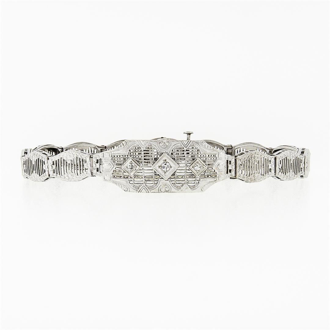 Antique Art Deco 14k White Gold 0.11 ctw Round Diamond Milgrain Filigree Bracele: An antique solid 14k white gold bracelet, with 3 round single cut natural diamonds (H- VS2; 0.11ctw). It weighs a total of 8.25 grams, measures 11.76mm wide, and measures 6.5 inches in length.