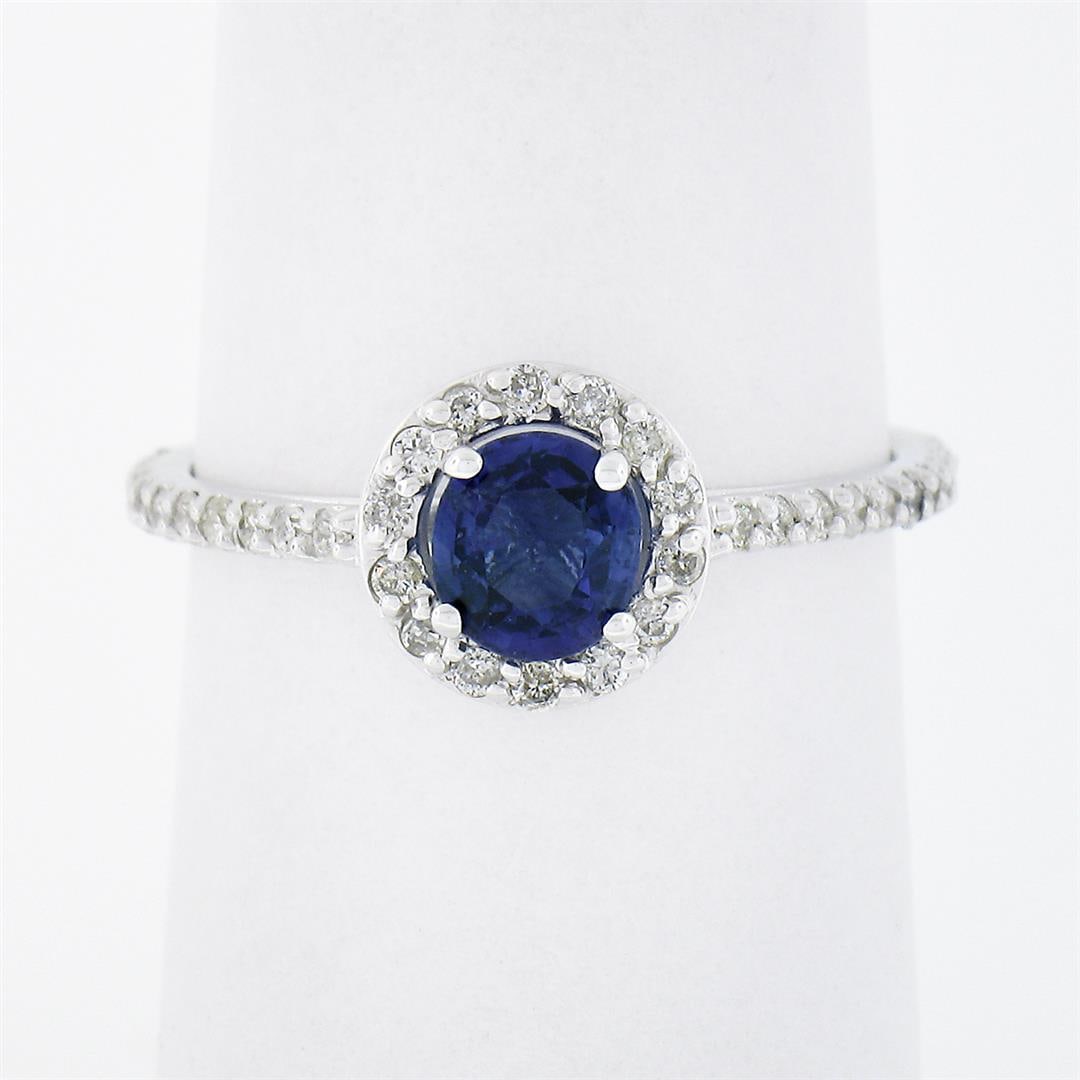 Petite 14K White Gold 1.01 ctw Round Sapphire Solitaire Diamond Halo Promise Rin: A soldi 14k white gold petite promise ring, featuring 1 round cut natural sapphire (5.0mm - 0.65ct), surrounded with a halo of 36 round brilliant cut natural diamonds (SI1/SI2 ; G/H - 0.36ctw). The ri