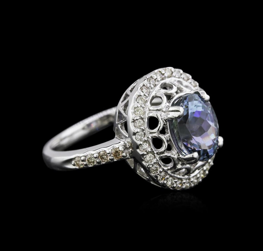 14KT White Gold 2.56 ctw Tanzanite and Diamond Ring: One electronically tested 14KT white gold ladies cast tanzanite and diamond ring with a bright polish finish. Identified with markings of "14K". Condition is new. Containing: One prong set oval modifi