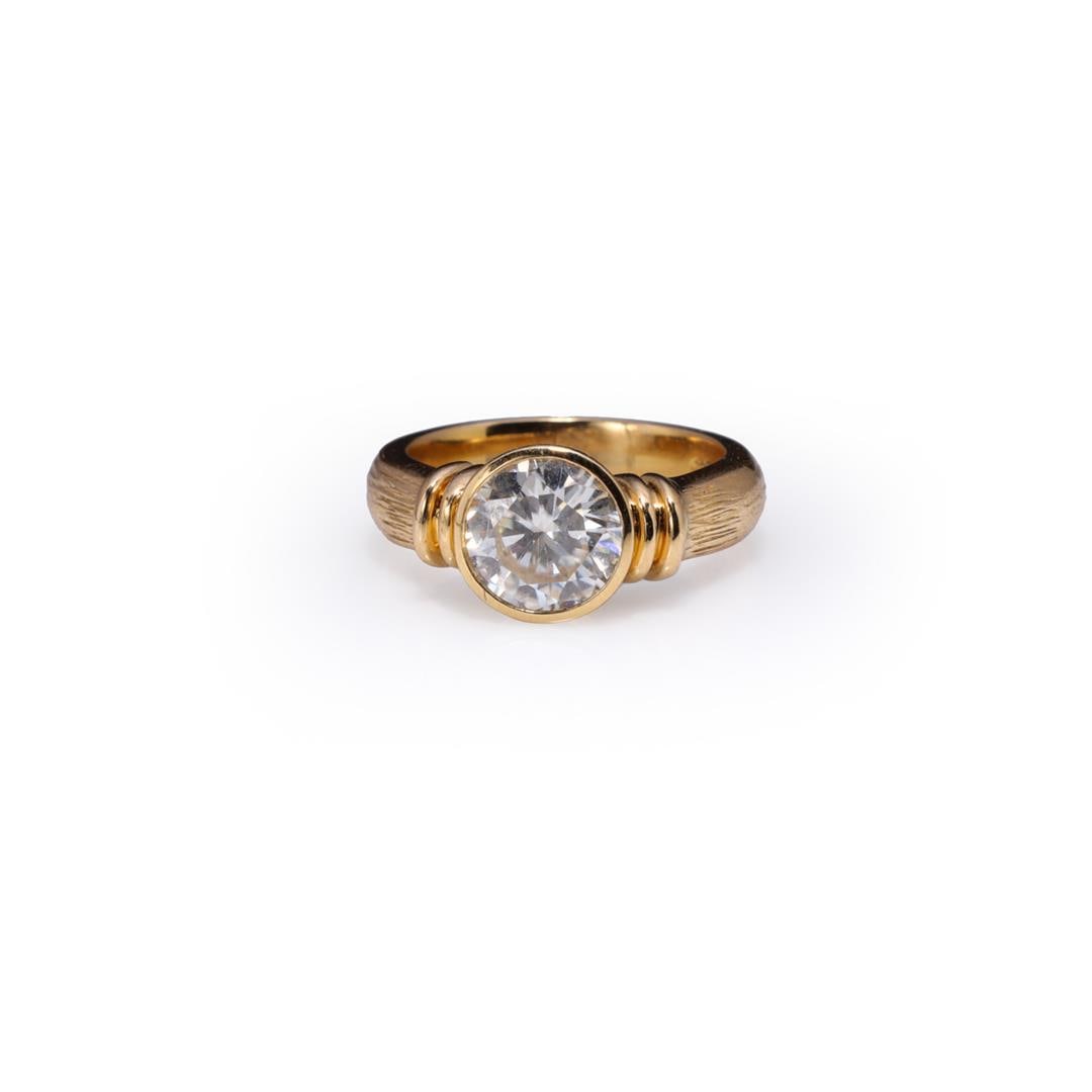 Heavy 18K Yellow Gold & Moissanite Ring: Heavy 18k yellow gold ring; bezel set with large round cut moissanite, marked 750 to interior band; gross weight 9.7 g, size 6 3/4