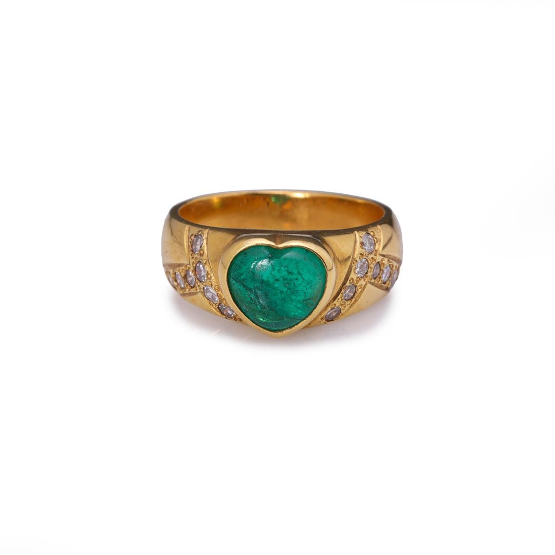 Vintage 18K Yellow Gold Emerald & Diamond Ring: Vintage 18k yellow gold ring; the center bezel set heart shaped emerald of good color, each shoulder with intersecting rows of diamonds; gross weight 11.7 g, size 8 1/2