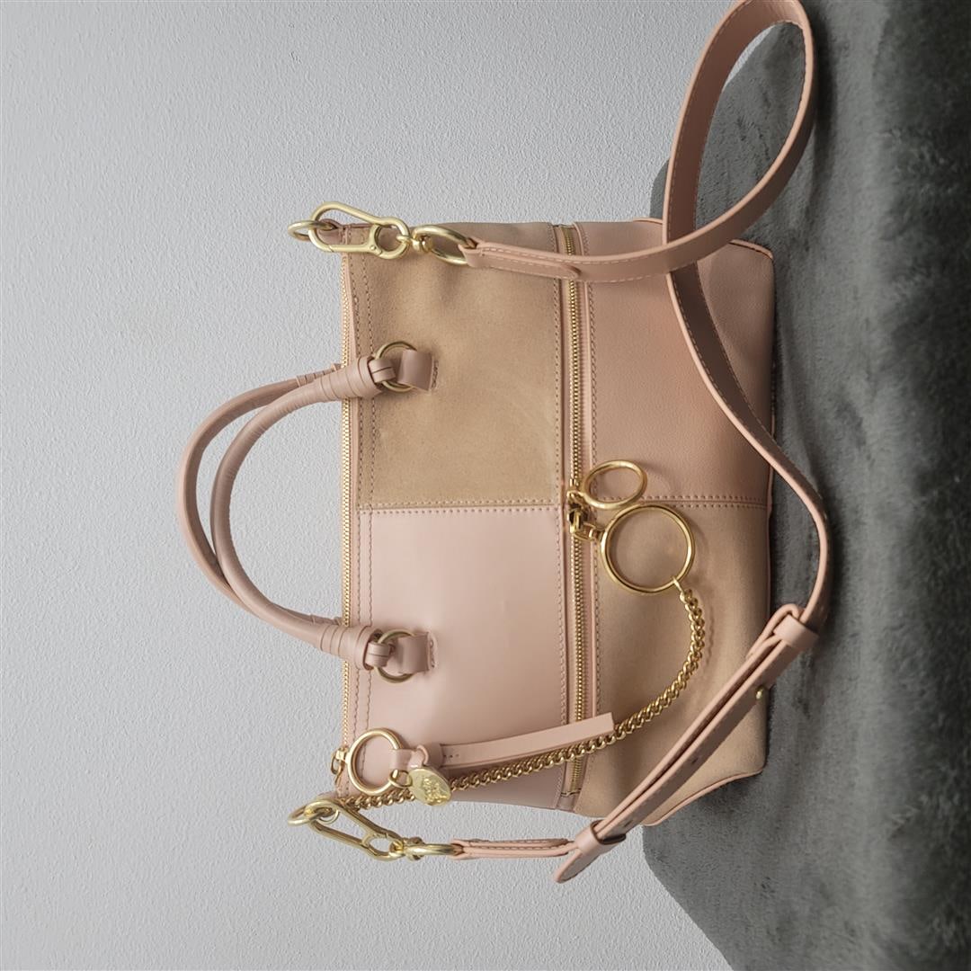 See by Chloe Medium Patch Bag in "Powder" w/ Gold Hardware: One See by Chloe Medium Patch Bag in "Powder" w/ Gold Hardware. Crafted in a patchwork design of pink leather and suede, this See by Chloe Emy bag is a roomy satchel that's designed to be able to take