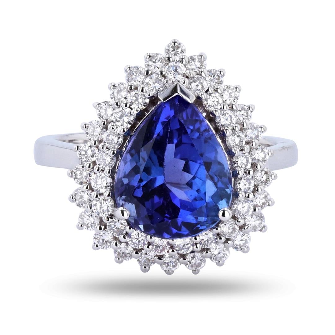 4.62 ctw Tanzanite and 0.85 ctw Diamond 18K White Gold Ring: One electronically tested 18KT white gold ladies cast tanzanite & diamond ring. Condition is new, good workmanship. The featured tanzanite is set within a tiered diamond bezel, supported by a ribbed u