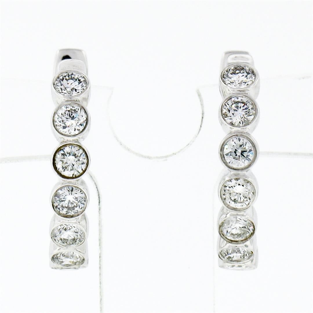 New 10K White Gold .49 ctw Round Brilliant Bezel Set Diamond Hoop Huggie Earring: A New pair of solid 10k white gold hoop earrings, with 14 round brilliant cut natural diamonds (G/H - SI1/SI2 ; 0.49 ctw). The earrings measure approximately 14.45x2.65mm and weigh a total of 2.0 gram