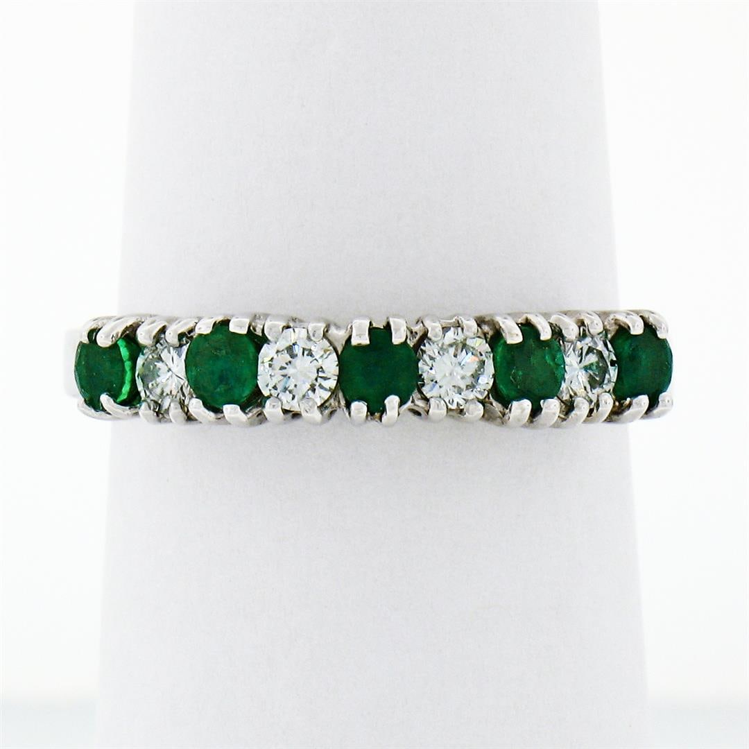 18k White Gold 1.36 ctw Alternating Round Diamond & Emerald Wedding Band Ring: An 18k white gold band ring featuring 5 round brilliant emeralds (0.80ctw) and 4 round brilliant diamonds (F/G - VS1/VS2; 0.56ctw) set in an alternating pattern. The ring is size 6.5, weighs a total o