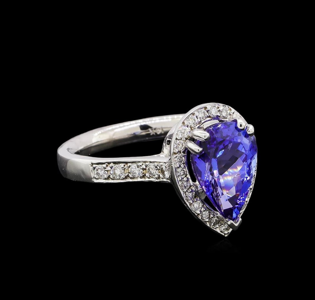 2.80 ctw Tanzanite and Diamond Ring - 14KT White Gold: One electronically tested 14KT white gold lady's cast fashion ring with a cathedral halo with a bright polish finish. The featured lady's ring has a shank measuring 2.50 millimeters wide. Identified w