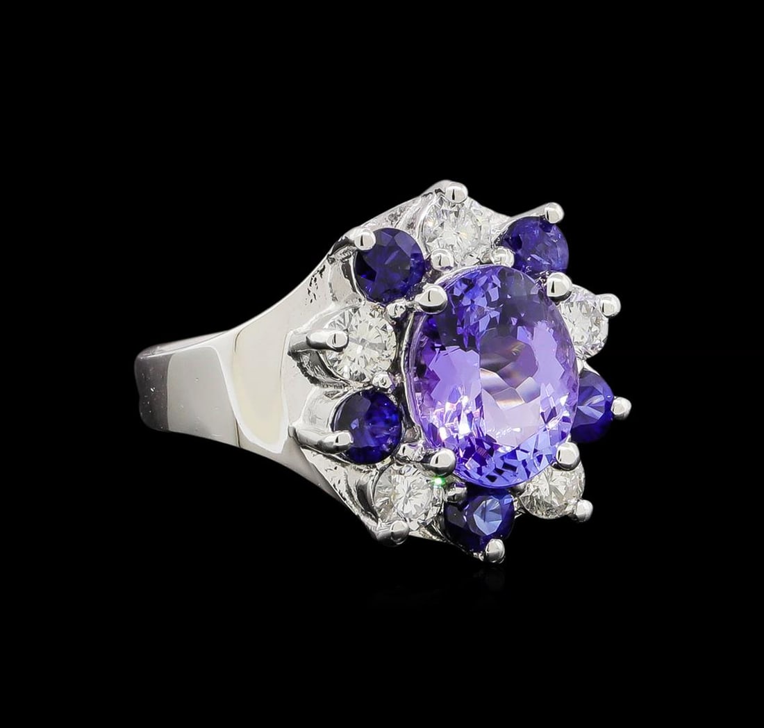 14KT White Gold 2.48 ctw Tanzanite, Sapphire and Diamond Ring: One electronically tested 14KT white gold ladies cast tanzinite, sapphire and diamond ring with a bright polish finish. Identified with markings of "K14". Condition is new. Containing: One prong set o