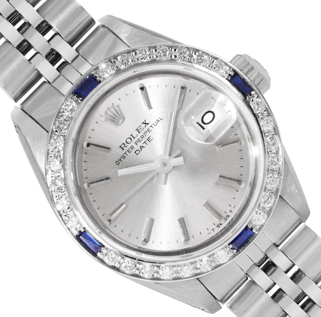Rolex Ladies Stainless Steel Silver Index Diamond And Sapphire Date Wristwatch: One Rolex Ladies Pre Owned Stainless Steel Date Wristwatch Polished Bright with Satin Finish, Serviced & Electronically Tested, Stainless Steel Case: 26mm, Stainless Steel Crown, Custom Bezel: New 18K