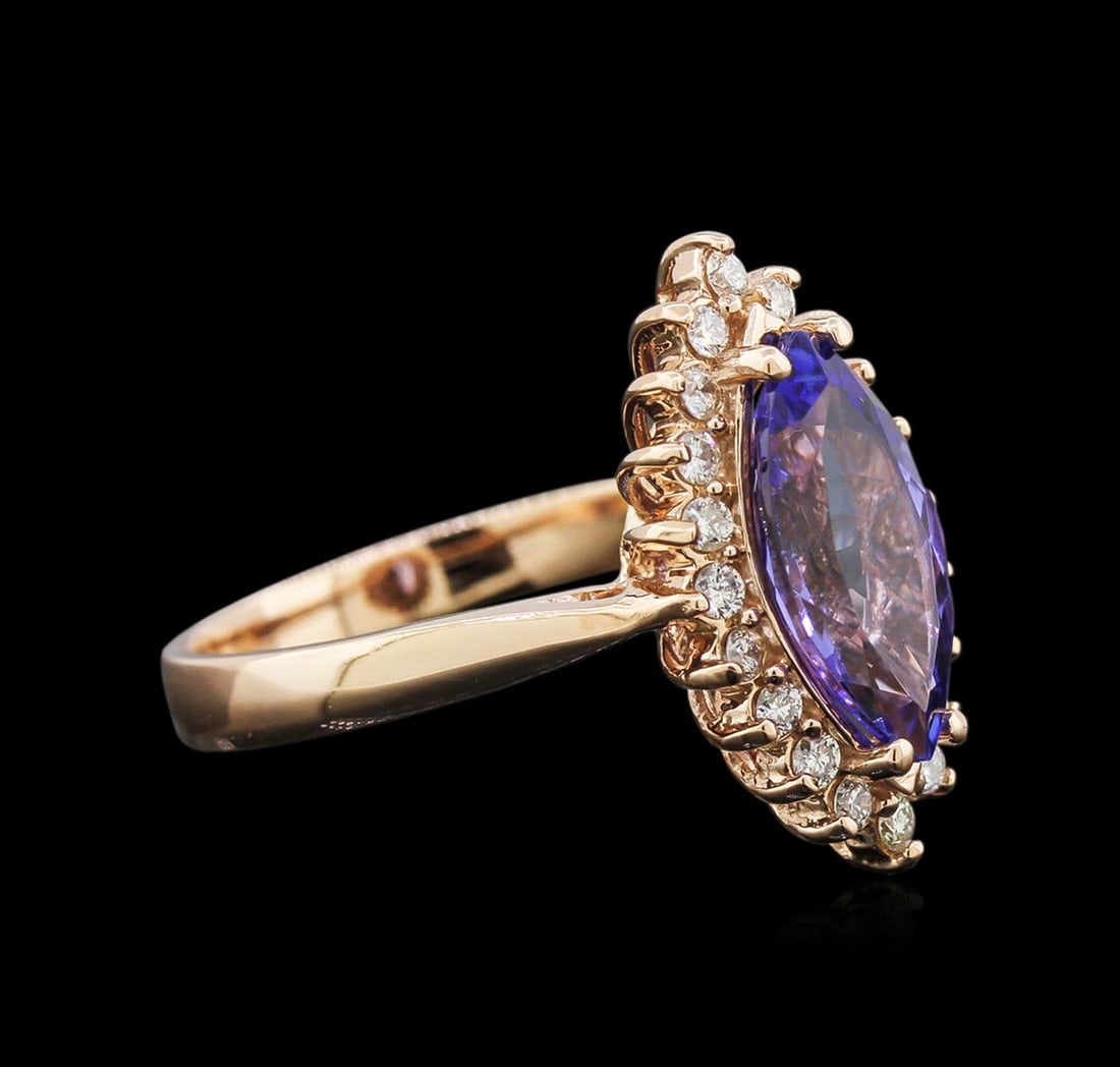 2.50 ctw Tanzanite and Diamond Ring - 14KT Rose Gold: One stamped & tested 14KT rose gold lady's cast cocktail ring with a cathedral shank with a bright polish finish. Condition is new. Containing: One prong set marquise modified brilliant cut natural ta
