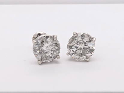 4.01 ctw Diamond Stud Earrings - Platinum: This pair of platinum stud earrings features two round brilliant cut diamonds with a total weight of 4.01ct, set in bright-polish basket settings with threaded posts. One diamond weighs approximately