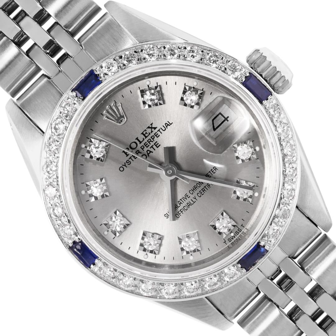 Rolex Ladies Stainless Steel Gray Diamond And Sapphire Date Wristwatch 26MM: One Rolex Ladies Pre Owned Stainless Steel Date Wristwatch Polished Bright with Satin Finish, Serviced and Electronically Tested, Stainless Steel Case: 26mm, Stainless Steel Crown, Custom Bezel: New 1