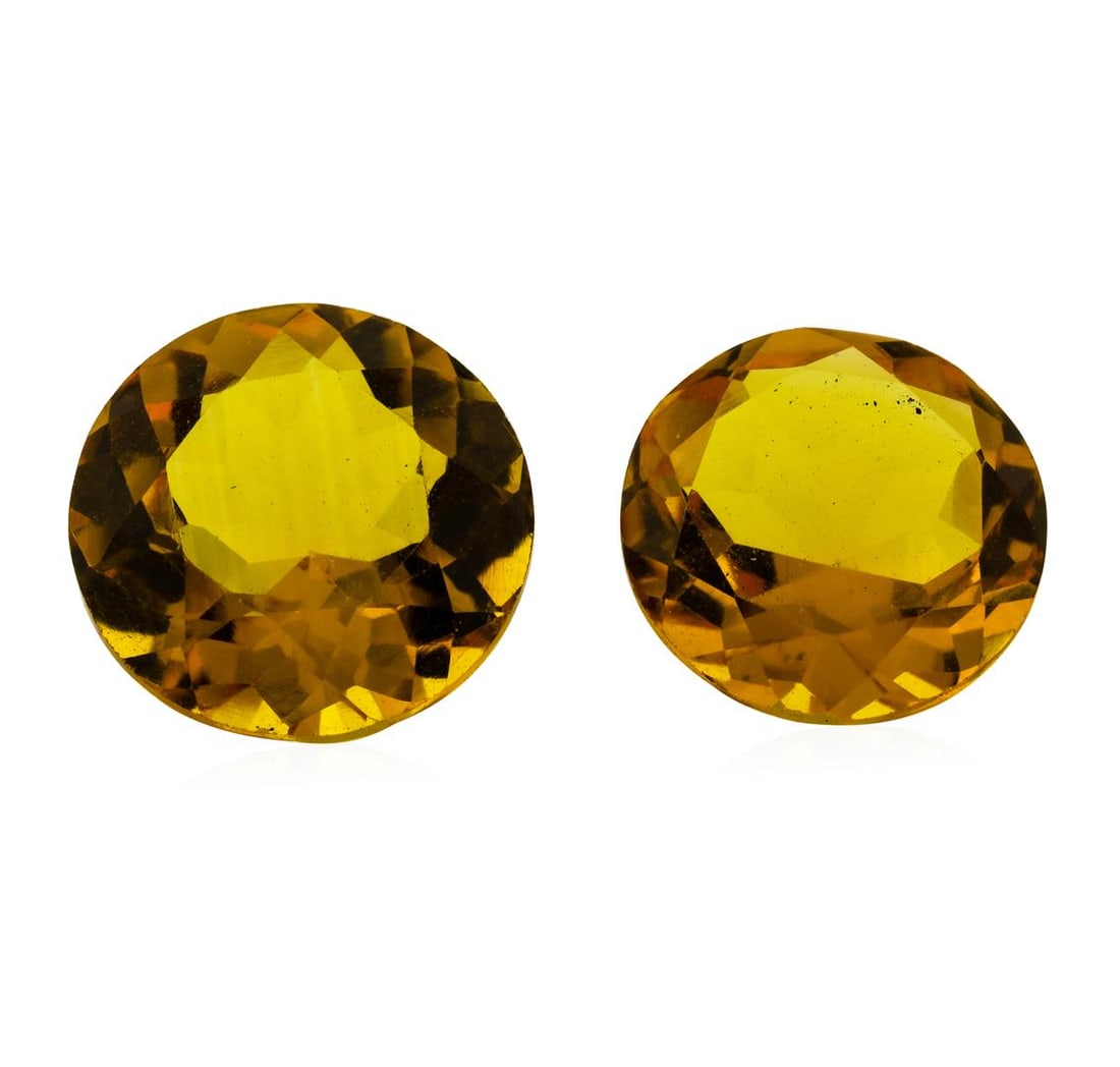 9.65 ctw.Natural Round Cut Citrine Quartz Parcel of Two: One natural round cut citrine quartz parcel of two with an exact weight of 9.65ctw., clarity is eye clean, yellowish orange, medium dark. Gemological Appraisals Services estimates the retail value at