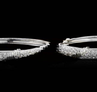14KT White Gold 2.30 ctw Diamond Bangle Bracelet: One electronically tested 14KT white gold ladies cast diamond bangle bracelet with a hidden box clasp with safety closer with a bright polish finish. Identified with markings of "14K". Condition is ne