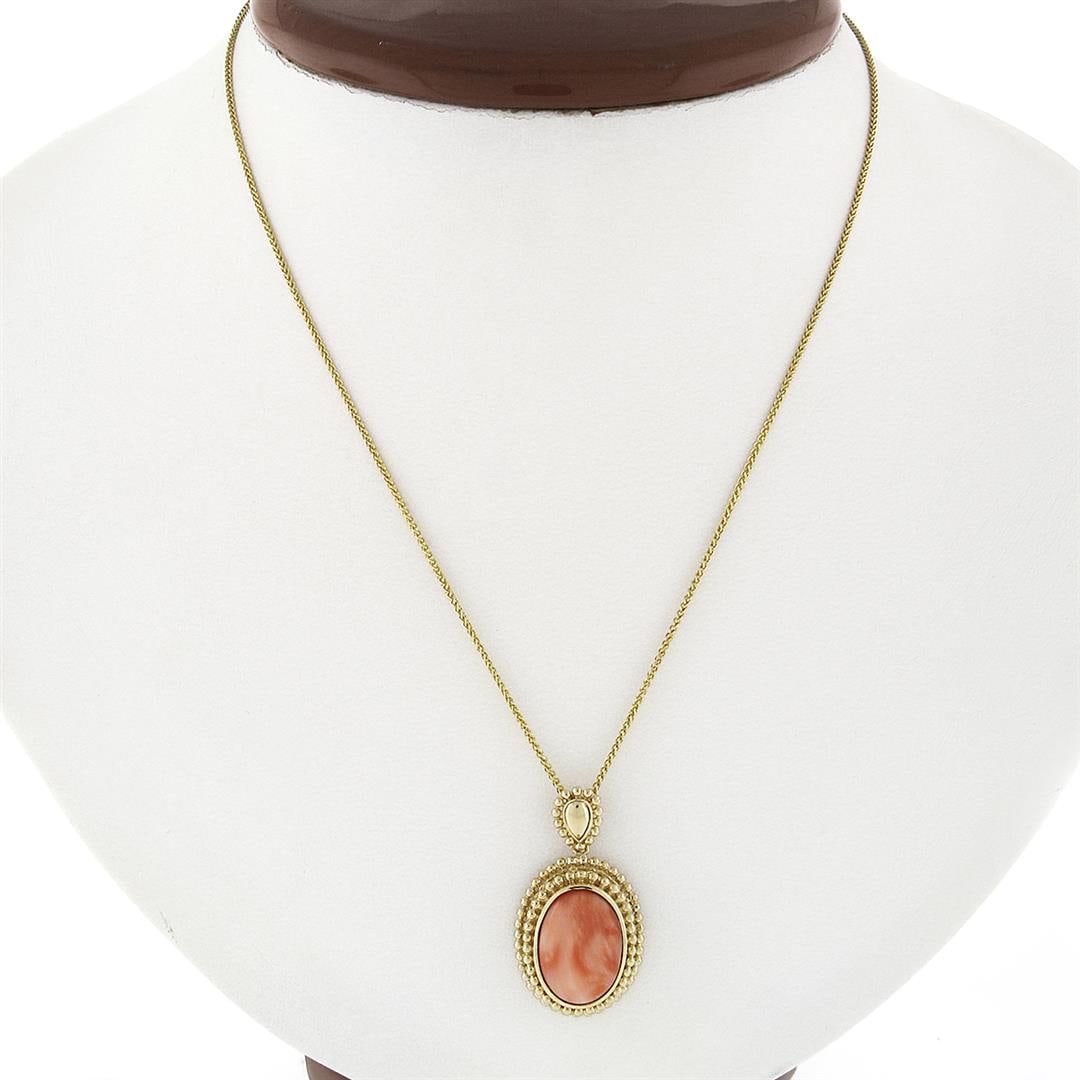 Vintage 14k Gold Oval Cabochon Coral Open Beaded Frame Pendant w/ Chain Necklace: A vintage solid 14k yellow gold pendant necklace, with 1 ova, cabochon cut natural coral (14.3x10.3mm). The pendant weighs a total of 6.54 grams, measures 20.25x16.1mm including the bail, and 18 inch