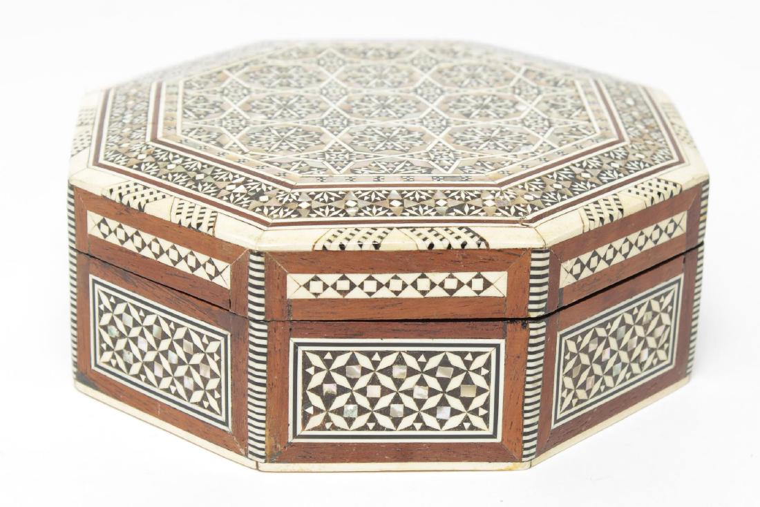 Syrian Trinket Box, Walnut & Mother-of-Pearl Inlay: Vintage Syrian octagonal walnut trinket box inlaid with tiny mother-of-pearl chips and strips of camel bone in Moorish patterns, the interior lined in cobalt blue velvet. 2.15" H X 5.75" diameter.