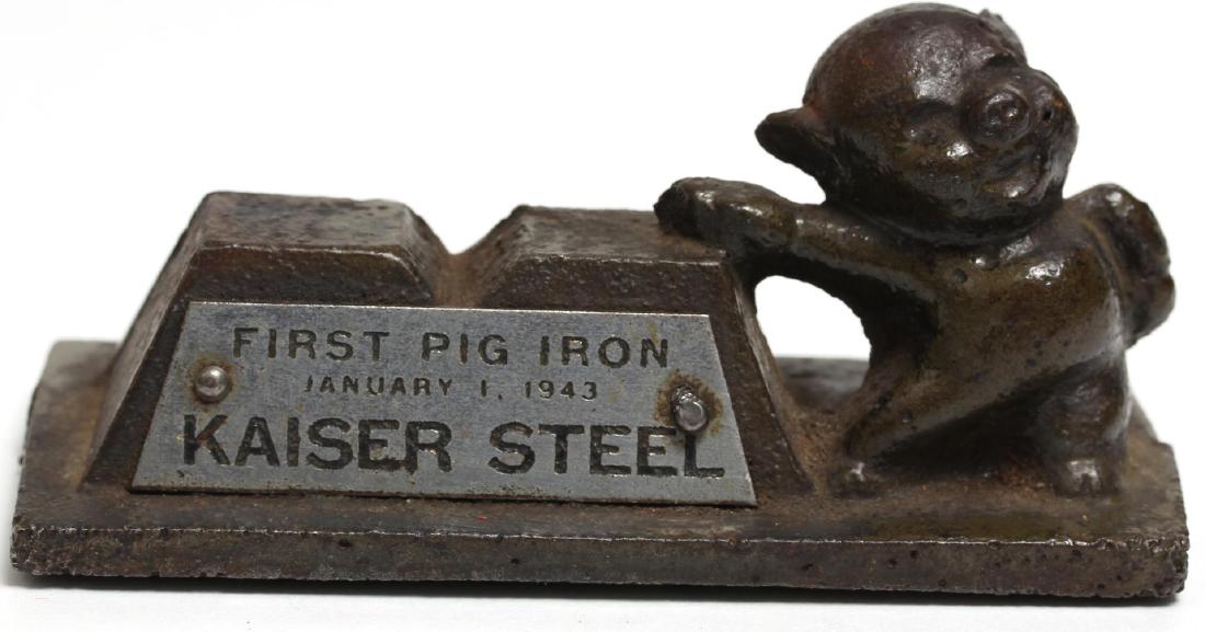 Vintage Kaiser Steel "First Pig Iron" Paperweight: Vintage paperweight by Kaiser Steel, depicting a happy pig in overalls, dated January 1, 1943, made to commemorate the opening of a Kaiser Steel plant in Fontana, CA. 2" H X 4" W X 1.5" D.