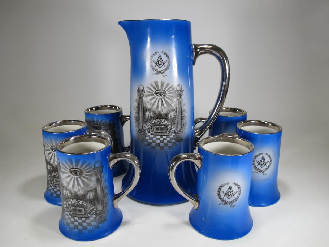 O'Beirne Brothers Masonic jug and 6 tankards set: O'Beirne Brothers tall jug and 6 tankards set. Blue with platinum rim and handle and Freemasonry emblems transfer in black. One tankard is stamped Maddock's Son's Co. in the base. Jug: 12 3/8" H x 6 1