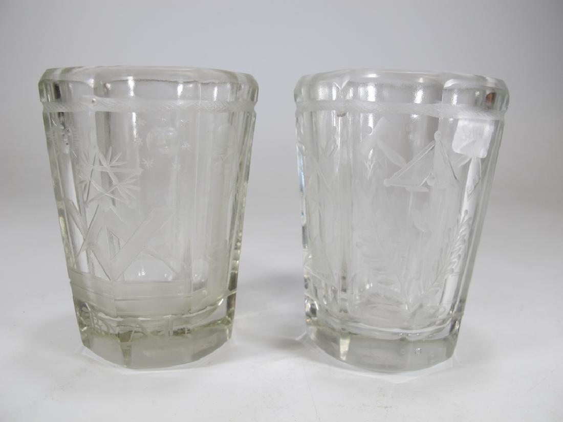 Pair of Masonic firing glass tumblers: Pair of firing glass tumblers. Engraved with profusion Masonic symbols. Octagonal base. Initials engraved in the lower part of both tumblers. 3 3/4" H x 2 7/8" W. Shipping in USA or International plea